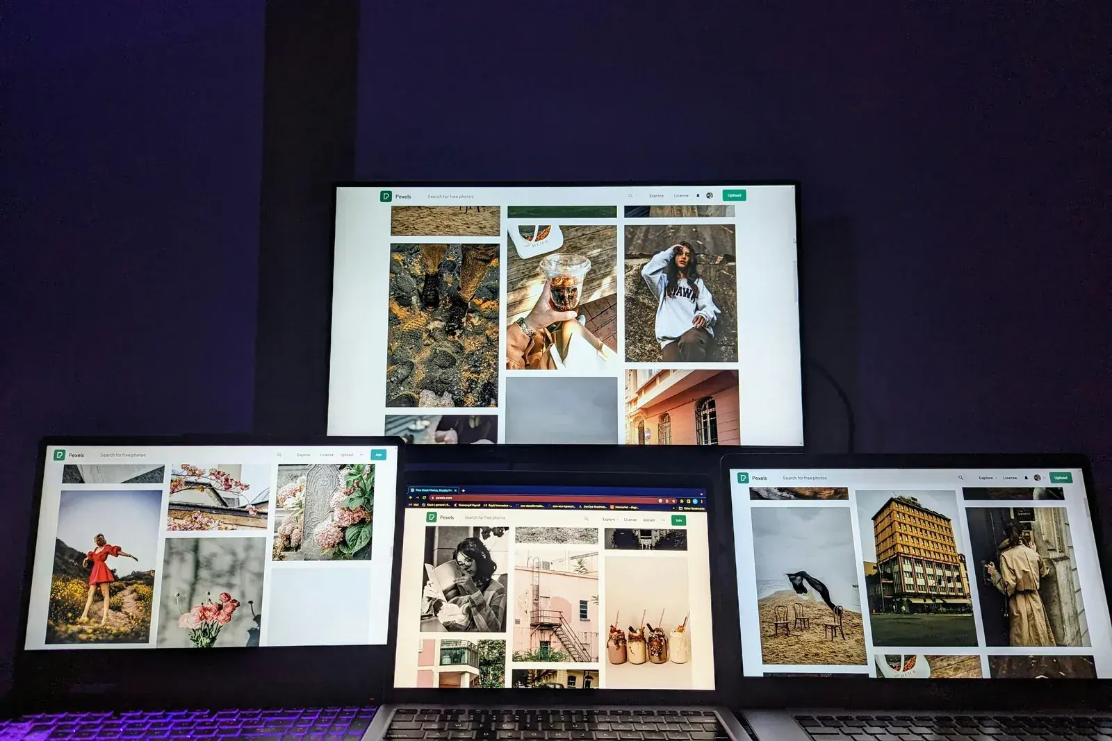 Multiple laptop screens showing a digital workspace setup