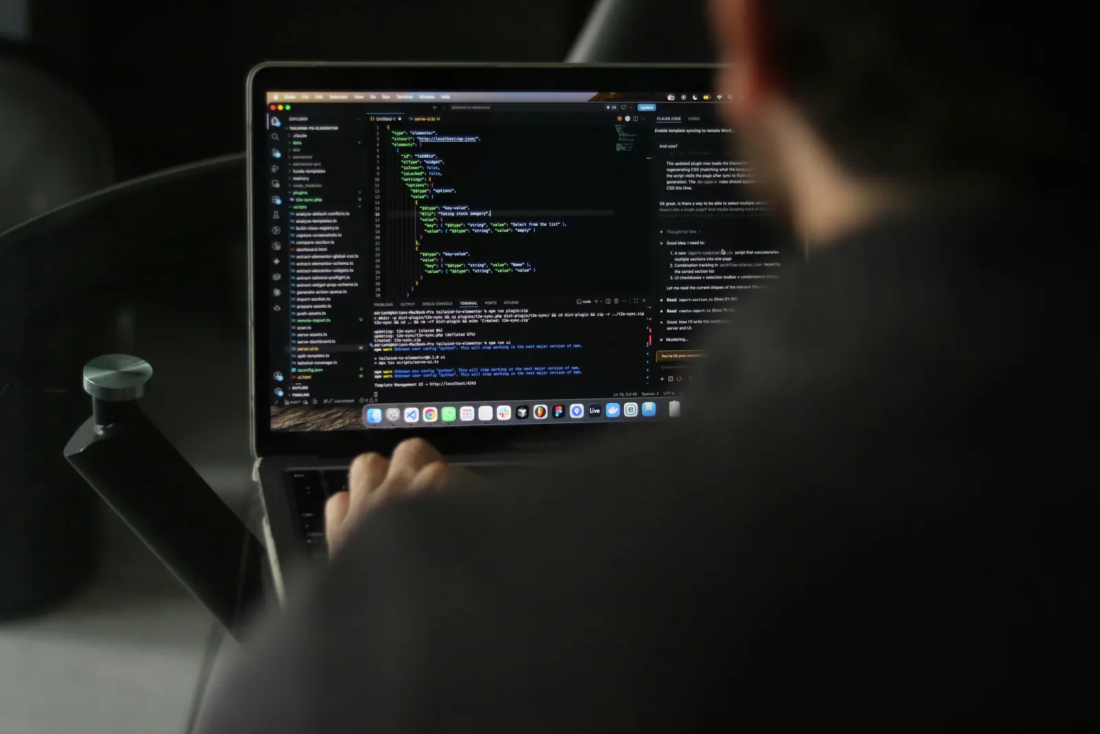 Developer typing code on a laptop while building an Electron app