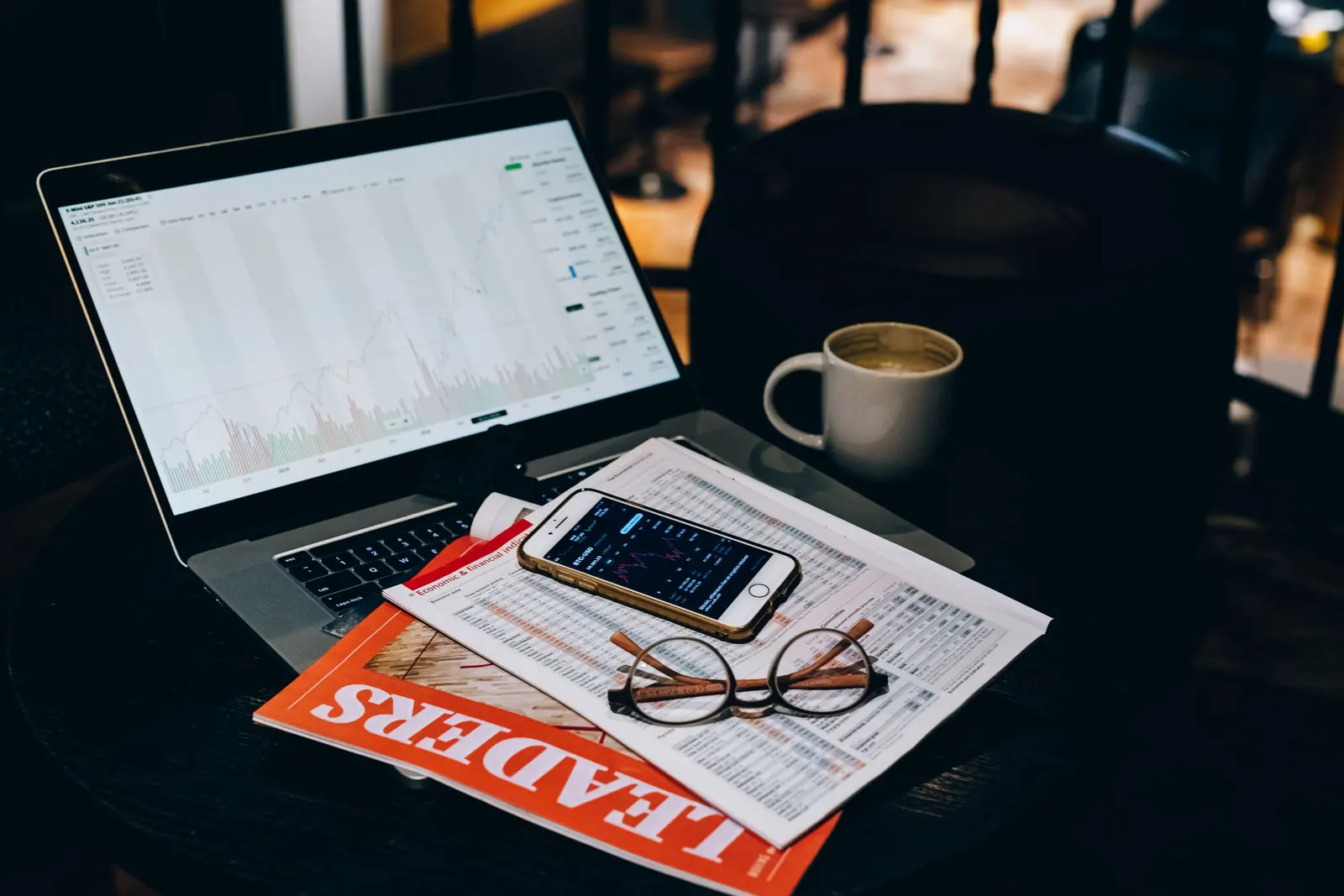 A laptop and printed documents arranged for a content review